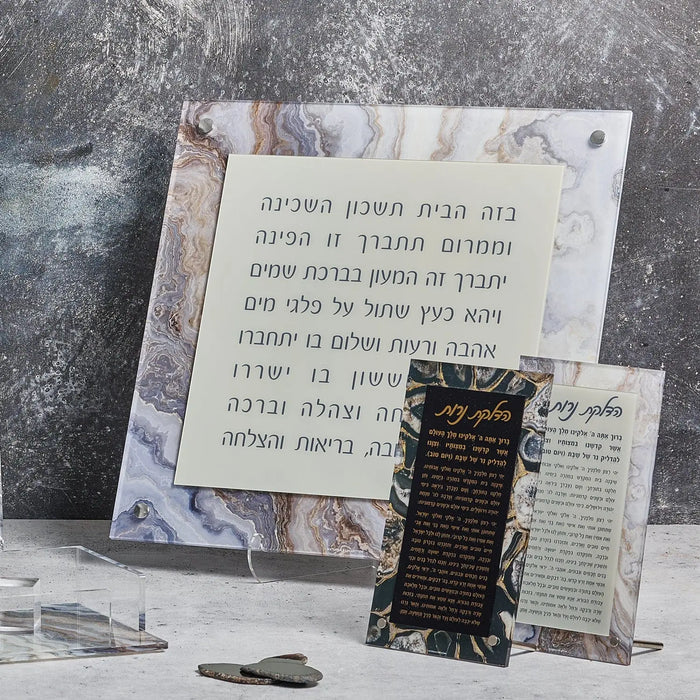 Agate Birchas Habayis floating wall art with Hebrew text on natural stone slice, displayed on gray surface with small decorative items