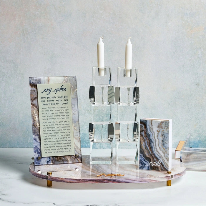 Agate Hadlokas Neiros tray with white candlesticks and informational cards on natural stone base for Shabbat candle lighting.