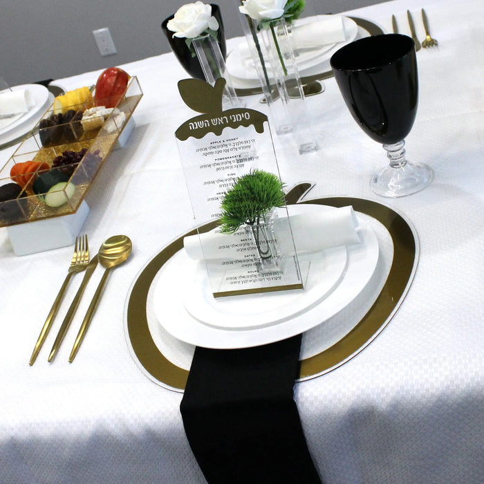 Silver apple simanim tabletops set at each place for Rosh Hashana