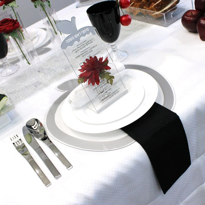 Silver apple simanim tabletops styled for a Rosh Hashanah place setting