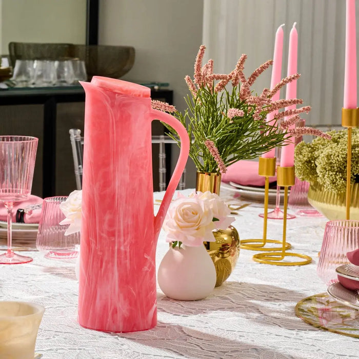 Blush pink faux floral vase with gold accents displayed on a styled table with greenery and candles, part of Waterdale Collection.
