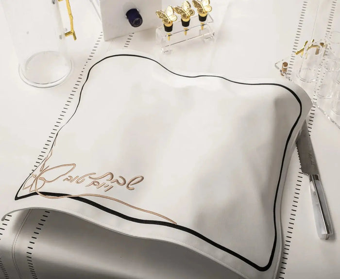Butterfly Challah Cover in silver leather with gold embroidered butterfly details, displayed flat on white background with matching accessories.
