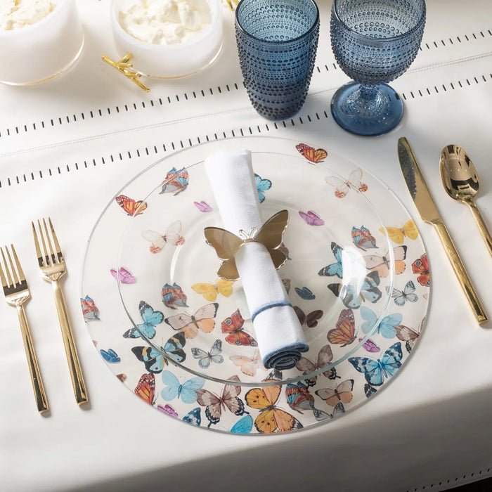 Waterdale butterfly chargers featuring colorful illustrated butterflies and florals on white ceramic plates, displayed with place settings and blue glassware.