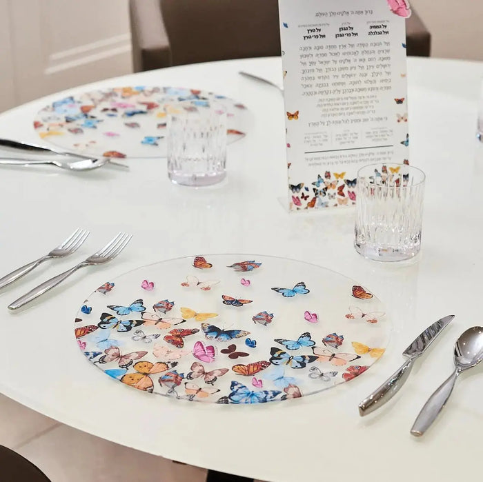 Waterdale butterfly chargers with colorful floral design displayed on white table with place settings and flatware, showing decorative tableware for holiday meals.