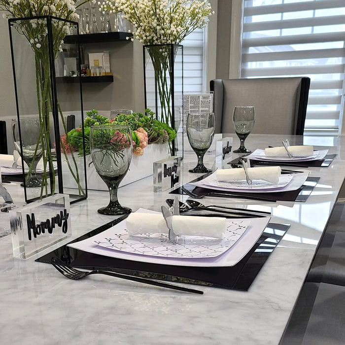 Black butterfly napkin rings displayed on a formal dining table setting with place settings and centerpieces by Waterdale Collection.
