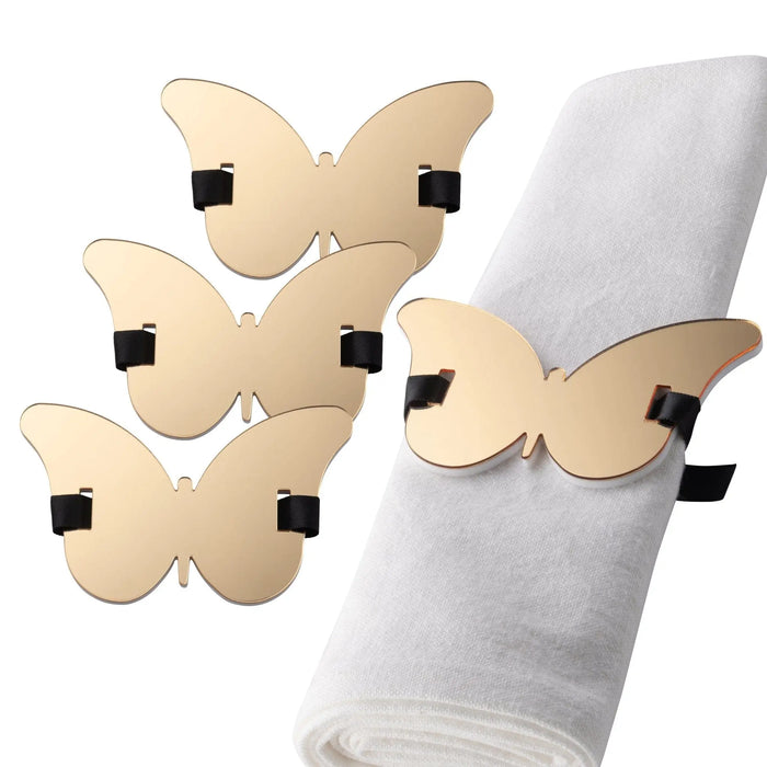 Butterfly napkin wraps in gold with black accents, displayed on a folded napkin for table setting decoration.