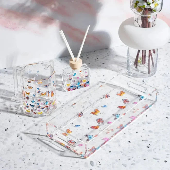 Butterfly Netilas Yadayim Set by Waterdale featuring clear acrylic cups with colorful butterfly designs and matching towel on marble surface