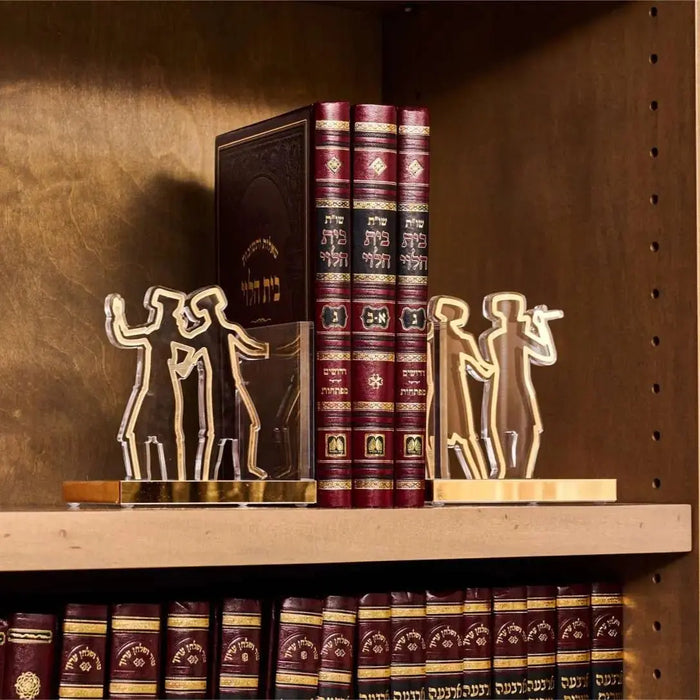 Pair of cream-colored Chassidim Book End Sculptures holding burgundy leather-bound books on wooden shelf, minimalist Jewish design.