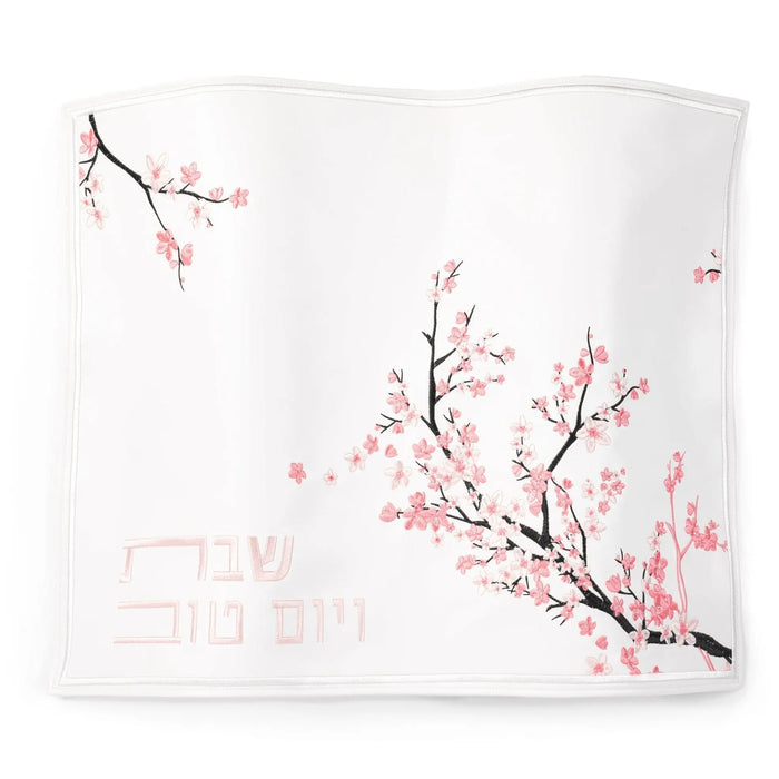 Cherry Blossom Challah Cover by Waterdale Collection featuring delicate pink floral branches on white fabric with silver and gold accents for Shabbat.