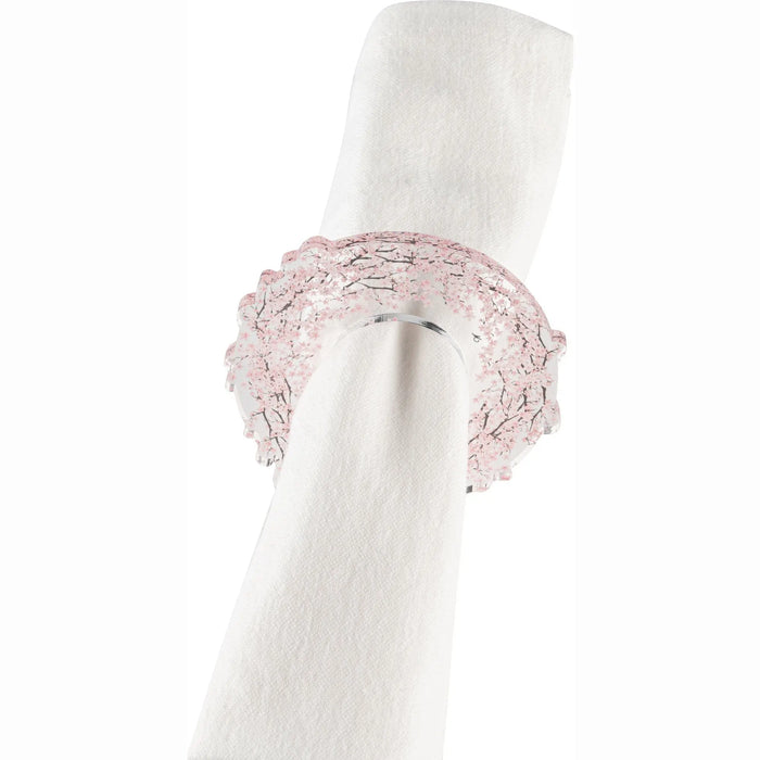 Cherry Blossom napkin rings in dusty pink with beaded texture detail, displayed on white rolled napkin for table setting.
