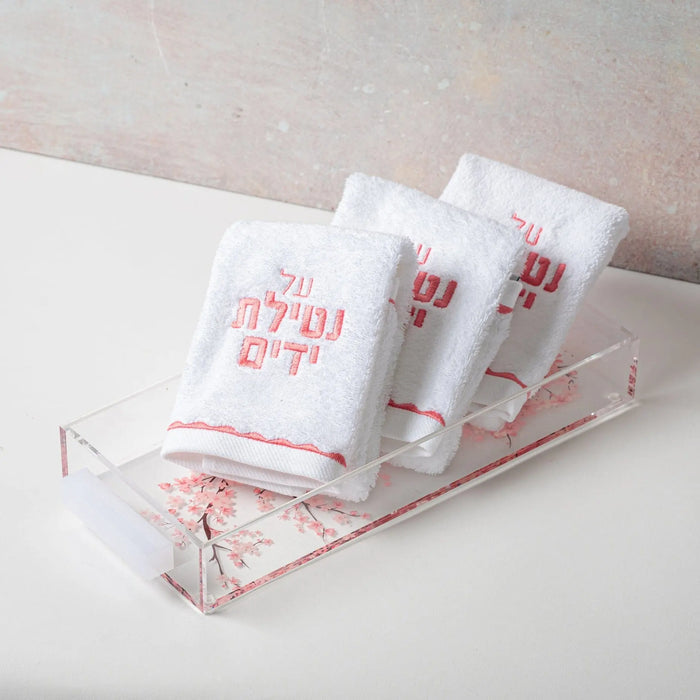 Cherry Blossom Towel Set by Waterdale Collection displayed in clear acrylic organizer with pink floral branding on white towel packaging.