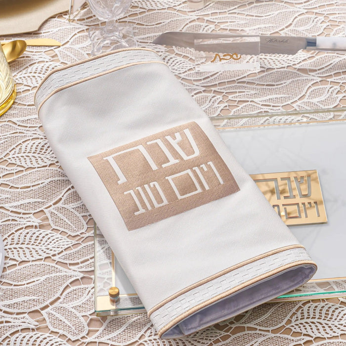 Classic 2.0 Challah Board by Waterdale Collection in white with gold Hebrew text design, displayed on textured surface with matching gold accent piece.