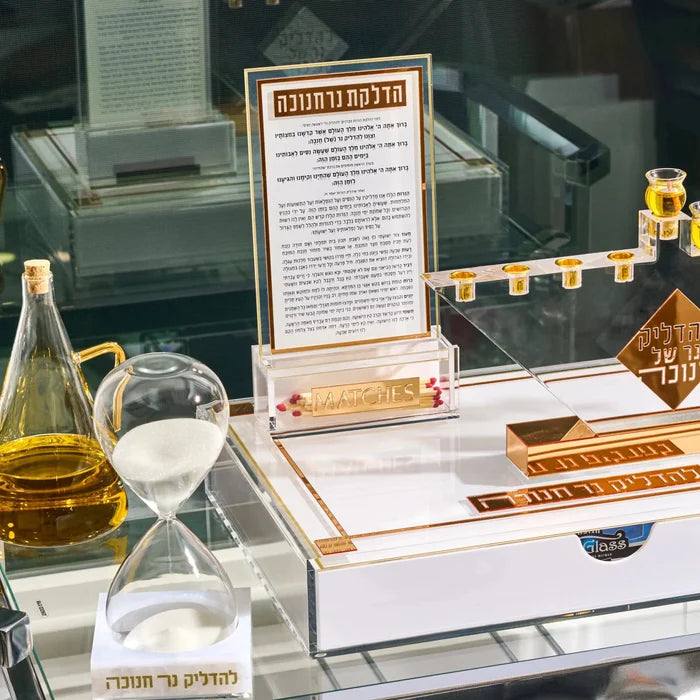 The Classic 2.0 Chanukah brachos card and its Lucite match holder standing on a menorah tray, set for Hanukkah lighting