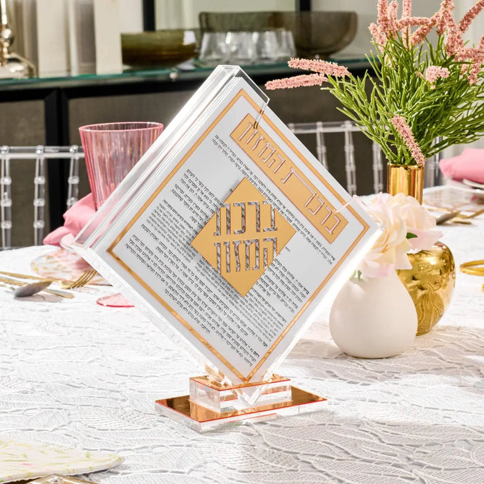 Classic 2.0 Diamond Bencher Set in geometric gold and white design, displayed on table with flowers and Shabbat items.