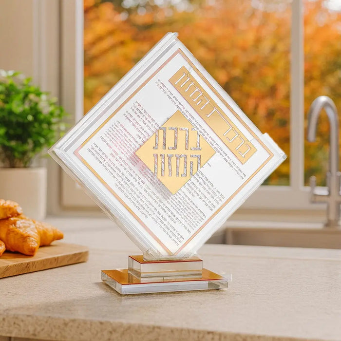 Classic 2.0 Diamond Bencher Set in white and gold displayed on table with autumn window backdrop and Shabbat items