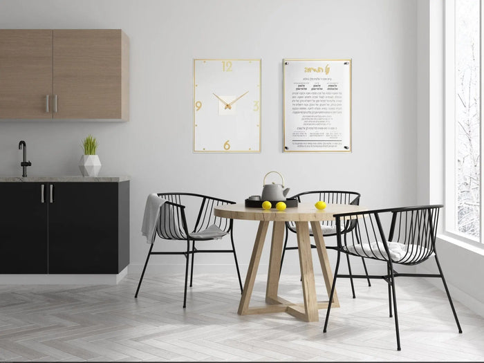 Classic Al Hamichyah wall art in gold frame displayed above dining table in modern kitchen setting with black chairs and wooden round table.