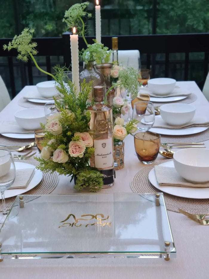 Classic wooden Challah Board by Waterdale Collection displayed on white Shabbat table with place settings and floral centerpiece.