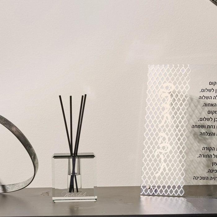 Classic Crystal Diffuser with clear glass base and black reed sticks, displayed on shelf with home décor accessories