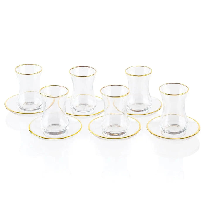 Classic glass cups and saucers with gold trim from Waterdale Collection, arranged in rows on white background, elegant Pesach tableware set.
