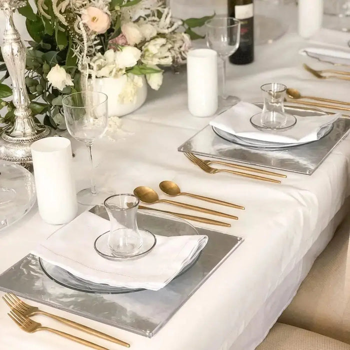 Classic glass cup and saucer from Waterdale Collection, displayed on elegant table setting with gold utensils and place cards