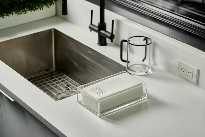 Classic Guest Towel Holder in brushed stainless steel displayed on a kitchen counter sink, perfect for bathroom vanities and entertaining.