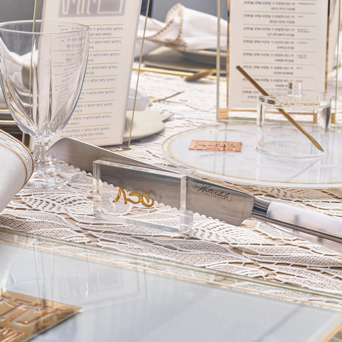 Wooden Classic Knife Stand by Waterdale Collection displayed on a table with challah board and Shabbat items nearby.