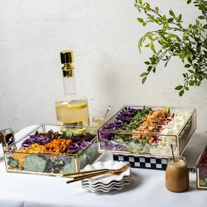 Gold glitter Classic Salad Bowl from Waterdale Collection displayed with serving utensils and white wine on a styled tabletop setting.