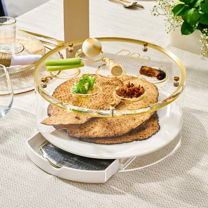 Classic Script Bencher Set Matzah Box in gold lucite displayed on white plate with Pesach tabletop styling and greenery accent