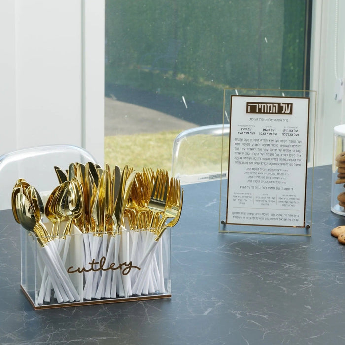 Classic Waterdale silverware caddy with gold-toned metal utensil holder displayed on counter with event card nearby.