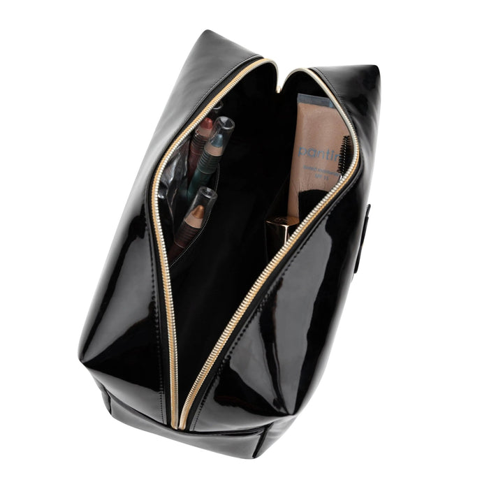 Black leather cosmetic bag with open top compartment displaying interior organization, featuring structured silhouette and handles from Waterdale Collection.