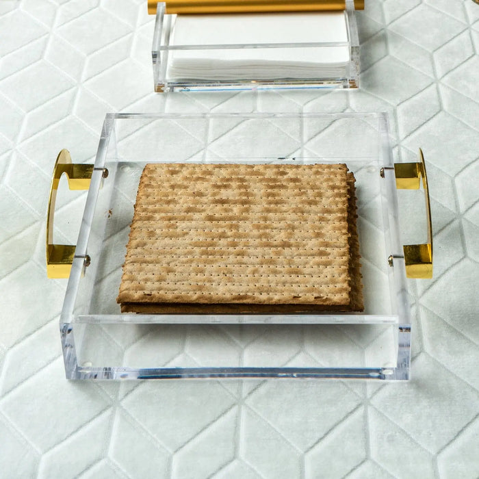 Clear lucite square tray cover with gold metal handles and woven rattan base insert for Passover serveware.