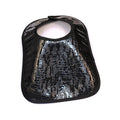 Black crocodile patent leather bib with textured embossed pattern and snap closure, designed for babies and toddlers by Waterdale Collection.