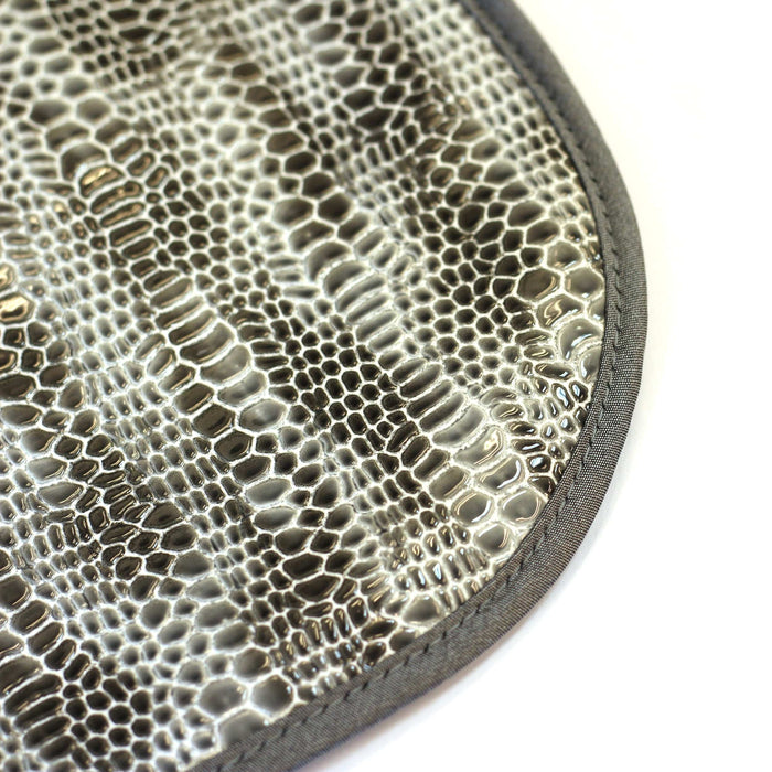 Crocodile patent leather bib in silver with textured embossed crocodile pattern and gray binding, displayed flat from above.