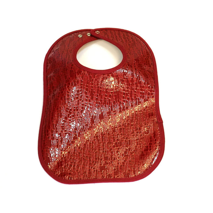 Red crocodile patent leather bib with textured pattern and snap closure, ideal for babies and toddlers by Waterdale Collection.