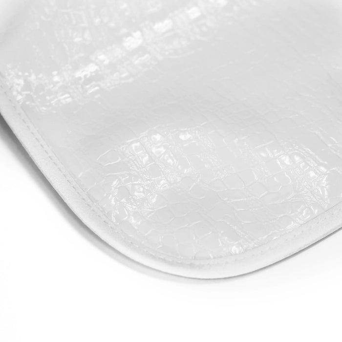 White crocodile patent leather bib with textured surface and curved shape, designed for babies and toddlers by Waterdale Collection.