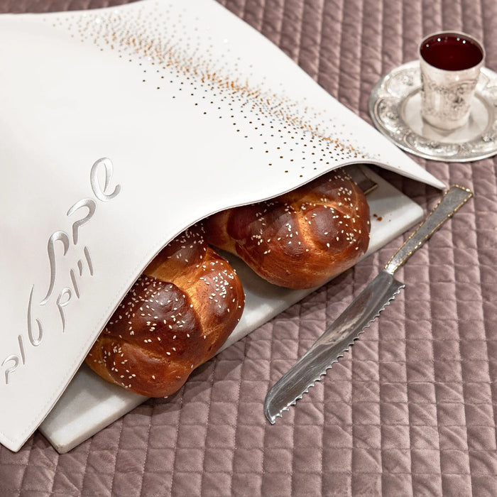 Crystal Challah Cover in gold with two fresh braided loaves on white linen, displayed for Shabbat service.