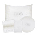 Crystal Pesach set by Waterdale Collection featuring white leather accessories including pillow, placemat, and round coaster on display.
