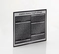 Black lucite custom chuppah card with Hebrew text, displayed at an angle showing the engraved design and professional wedding invitation layout.