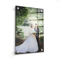 Custom print wall art featuring a bride in a white wedding dress standing outdoors by water, displayed on black acrylic mounting hardware in 16x20 size.