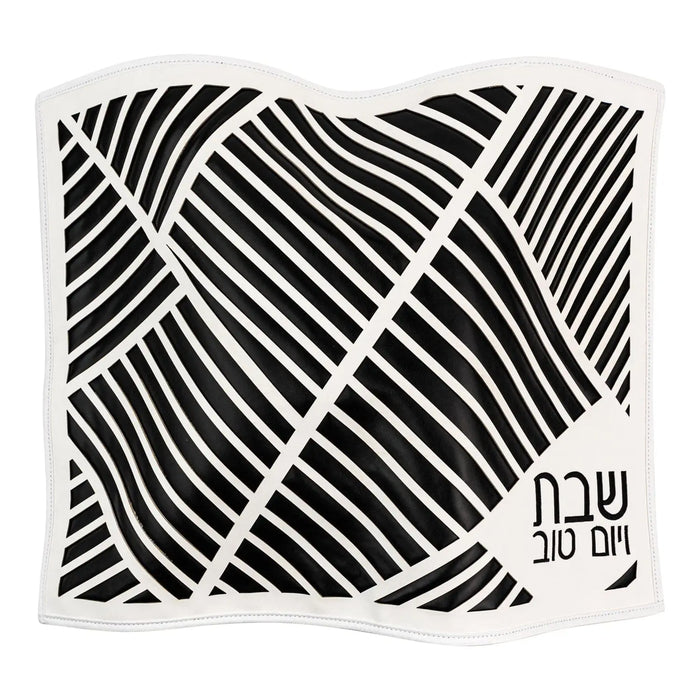 Black leather challah cover with diagonal laser-cut geometric pattern and metallic accents, Shabbat table décor by Waterdale Collection.