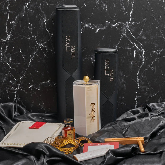 Diamond Leather Megillah Case in black with gold accents, displayed with black ribbon and decorative elements on marble background.