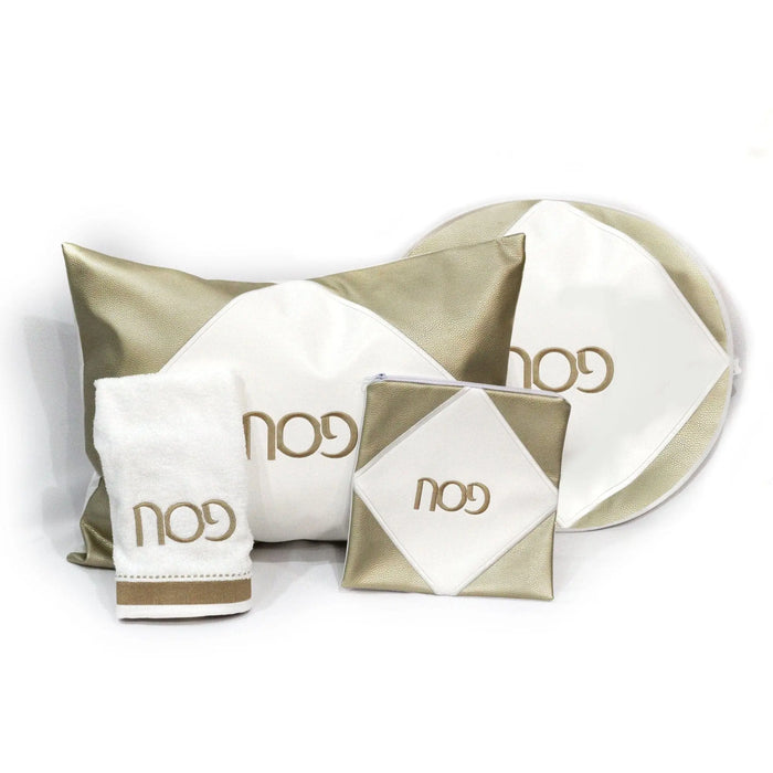 Diamond Pesach Set in cream and gold leather by Waterdale Collection, showing matching matzah cover, afikoman pouch, and serving pieces arranged on white background.