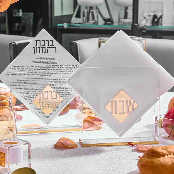 Diamond Suspended Bencher Set in white with gold monogram details, displayed on table with Shabbat items and candles