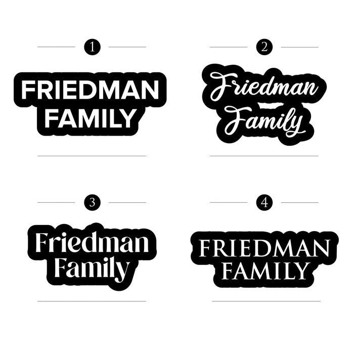 Four black door plaques displaying "Friedman Family" in different stylized fonts and layouts for personalized home wall art.