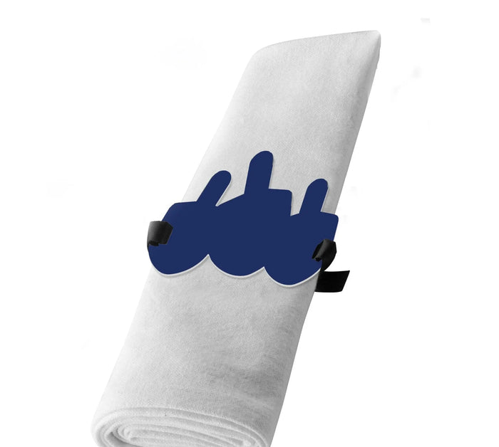 Blue Lucite dreidel napkin wrap holding a white napkin, one of a set of four for a Hanukkah table