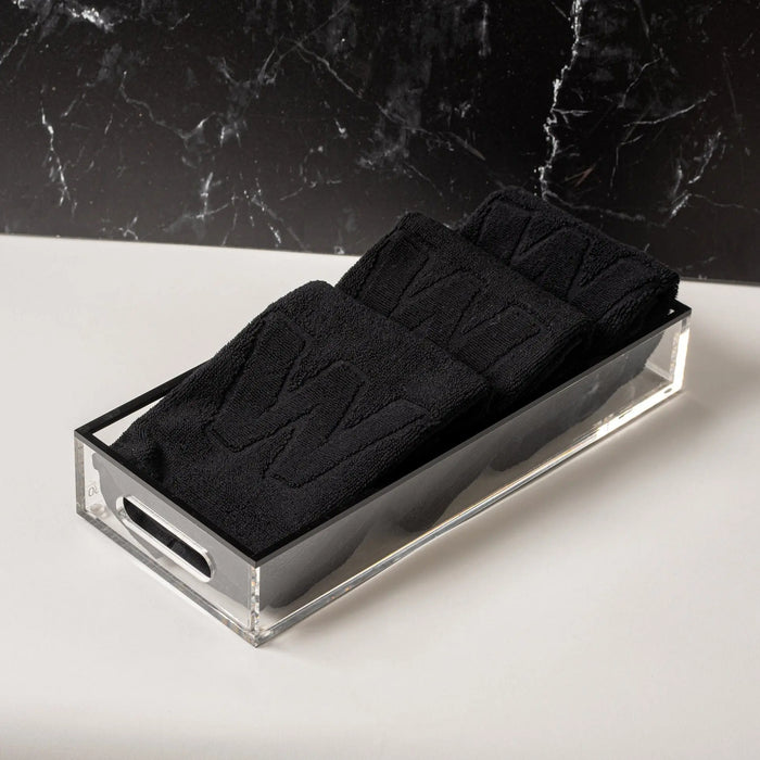 Black Edge Towel Set from Waterdale Collection displayed in clear acrylic holder on marble surface