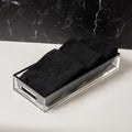 Black Edge Towel Set from Waterdale Collection displayed in clear acrylic holder on marble surface
