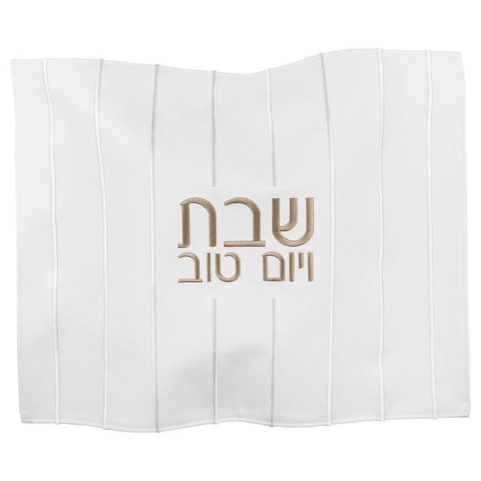White linen challah cover with embroidered gold Hebrew text and vertical stitch details for Shabbat.