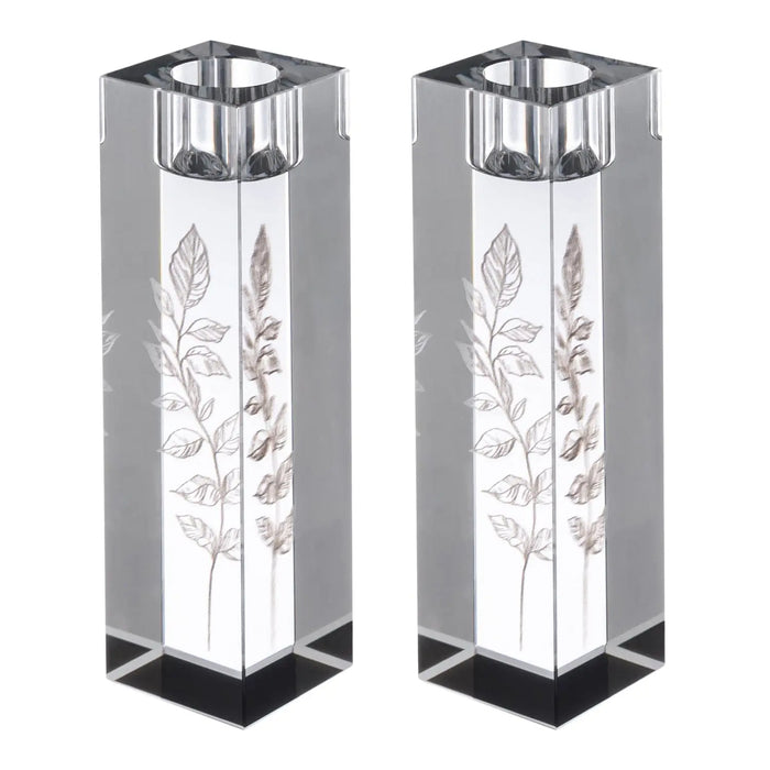 Pair of tall crystal candlesticks with engraved leaf designs and metal tops, ideal for Shabbat candle lighting ceremonies.