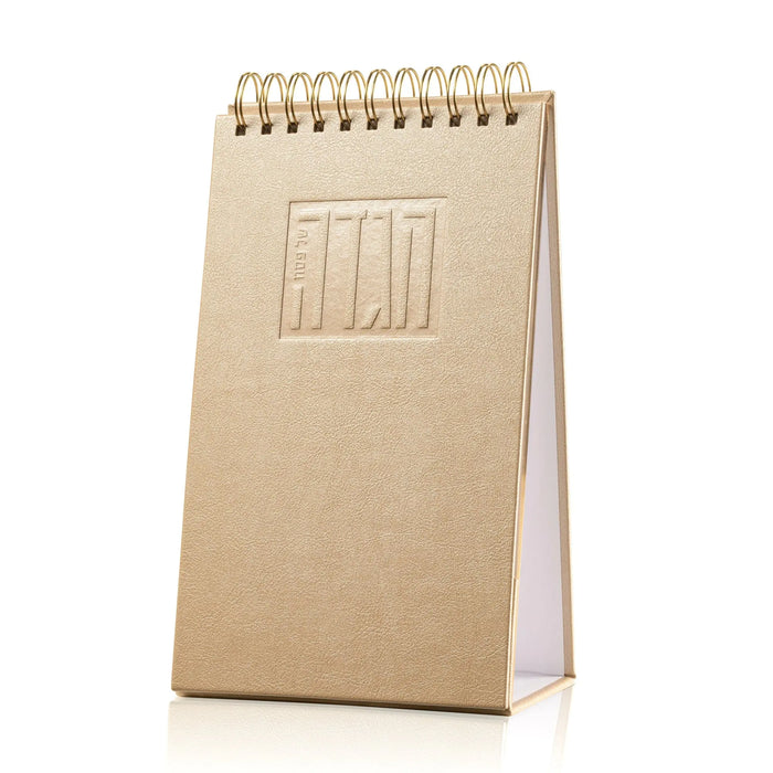 Tan leather standing Haggadah with spiral binding and embossed cover design for Passover services and Seder table use.